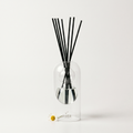 Bella reed diffuser - glass bottle with rattan reeds, product packshot