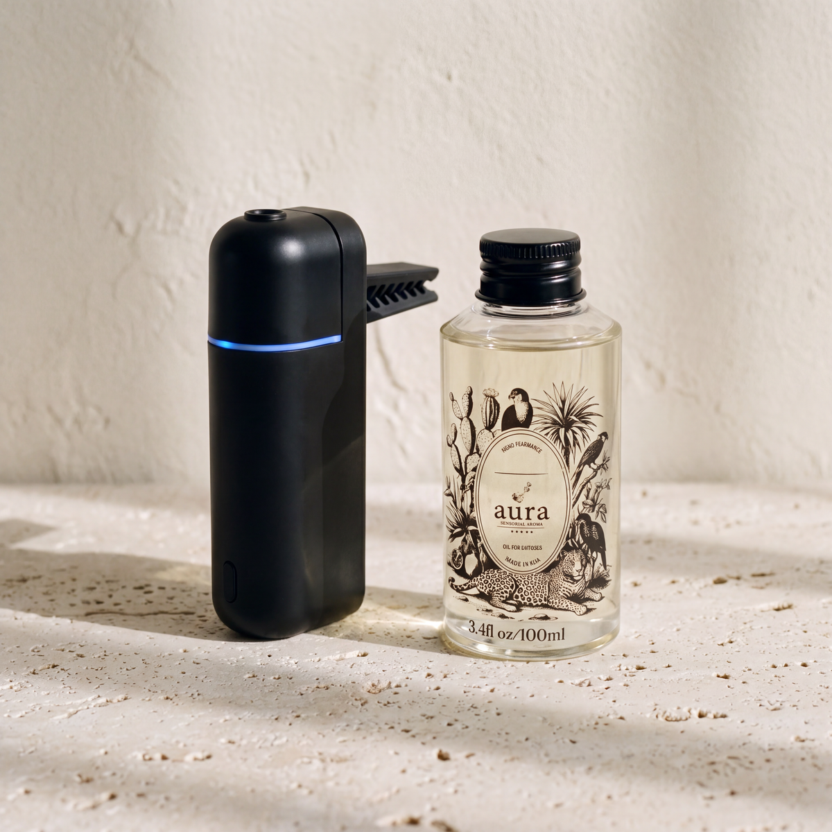 Black AURA Strada beside the 100 ml Aura fragrance oil bottle